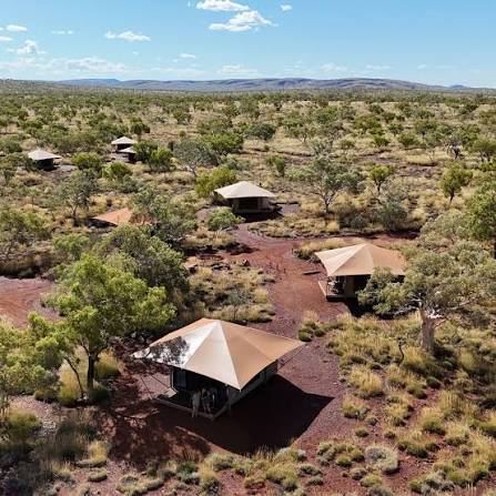 Aerial view of the eco tents at Karijini Eco Retreat scattered through red earth and spinifex